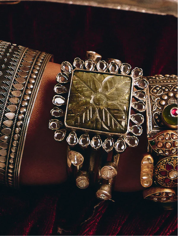 Dual Tone Twisted Cuff Bracelet with Sapphire and Carved Gold Charm