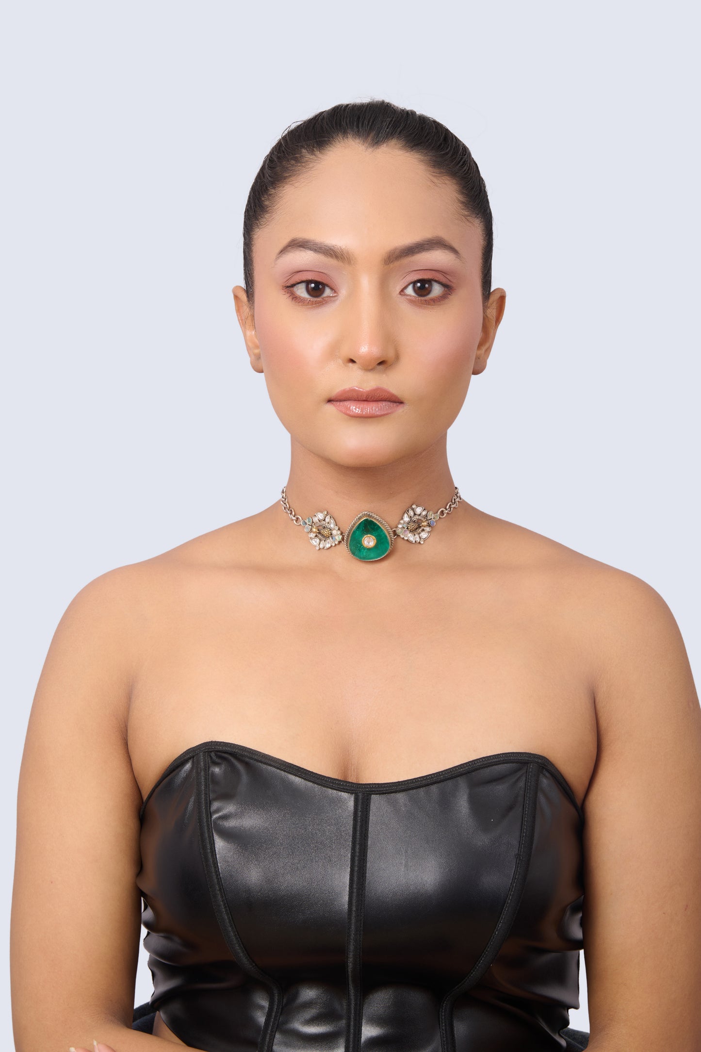 Silver Tone Necklace with Heart-Shaped Emerald, Gold Accent, and Floral Gem Details