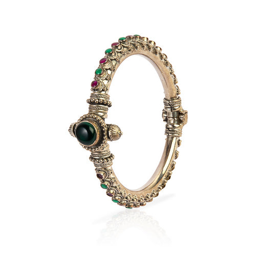Silver Tone Hinged Bangle with Central Green Gem, Ruby, and Emerald Accents
