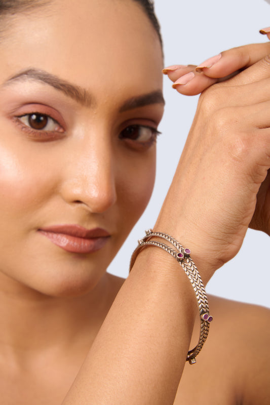 Pair of Oxidized Silver Braided Bangles with Red Gemstone Accents